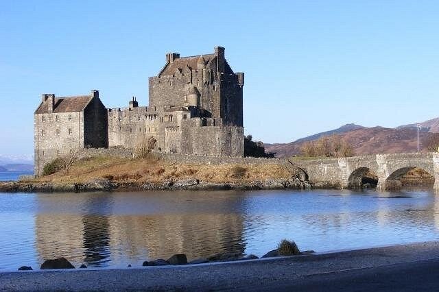 Eilean Donan Castle on its islet at Dornie, on the mainland just before the Skye Bridge, with the stone footbridge running out to it
