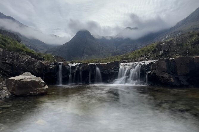 The Fairy Pools on a grey day, a double waterfall into a still pool with the Cuillin lost in low cloud