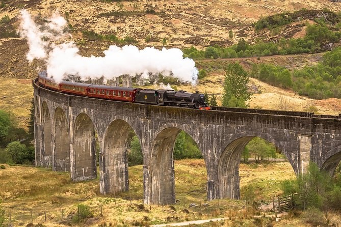 The Jacobite steam train crossing the Glenfinnan Viaduct on the mainland, the line some Skye tours ride to Mallaig