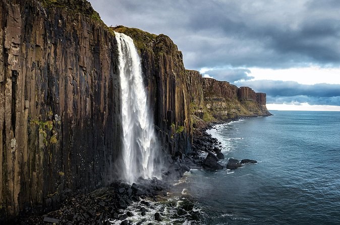 Kilt Rock's basalt columns with the waterfall pouring off the cliff edge into the sea below