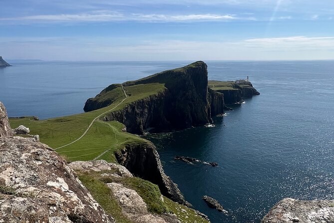 Neist Point from the cliff top above it, the path running out along the headland to the lighthouse