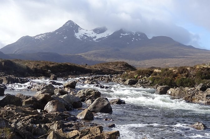 The river at Sligachan running over boulders, the peak of Sgurr nan Gillean under cloud behind it